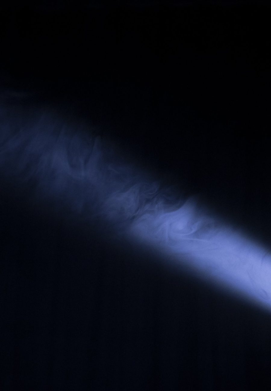 Beams of light cutting through haze in a dark space